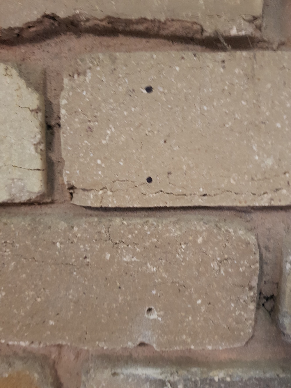 Brick wall small drilled hole